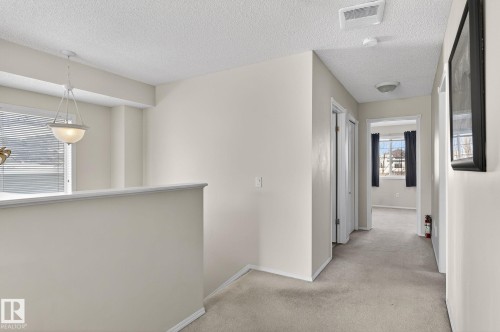 The property features neutral-toned walls, carpeting, and a window with blinds, allowing for natural light - 19 Escada Close, St. Albert, AB - Indoor Photo Showing Other Room