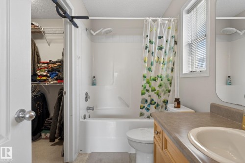 Bathroom with a vanity featuring a single basin sink and a window with blinds - 19 Escada Close, St. Albert, AB - Indoor Photo Showing Bathroom