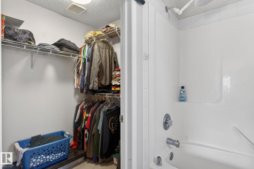 This property features a closet with wire shelving and a bathroom with a shower and tub combination - 19 Escada Close, St. Albert, AB - Indoor With Storage