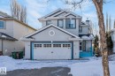 The property features a two-car garage with white doors, light grey siding, and dark trim details - 19 Escada Close, St. Albert, AB  - Outdoor 