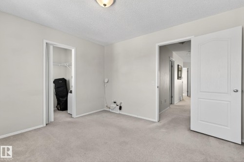 This room features light-colored carpet flooring and walls, with a white baseboard trim - 19 Escada Close, St. Albert, AB - Indoor