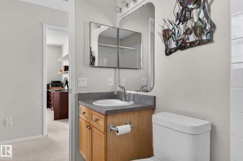 Bathroom featuring a vanity with wood cabinetry, a light-colored countertop, and a white sink - 19 Escada Close, St. Albert, AB - Indoor Photo Showing Bathroom