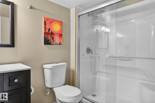 Bathroom featuring a dark wood vanity with a white countertop, a white toilet, and a stand-up shower with a glass enclosure - 19 Escada Close, St. Albert, AB - Indoor Photo Showing Bathroom