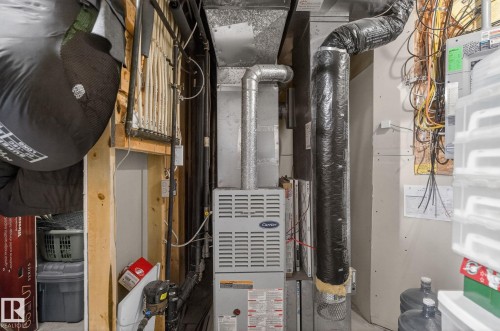 The property features a Carrier brand furnace and an extensive system of ductwork and wiring - 19 Escada Close, St. Albert, AB - Indoor Photo Showing Basement