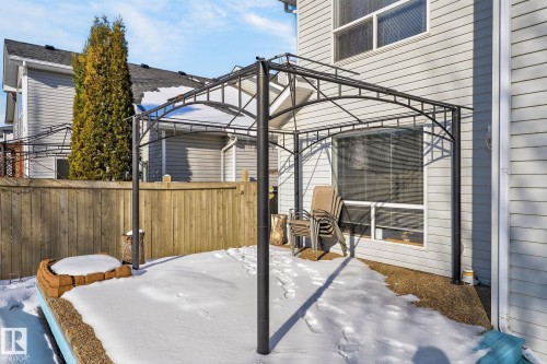 The property features a backyard with a wooden fence, a permanent gazebo structure, and a window with blinds - 19 Escada Close, St. Albert, AB - Outdoor With Deck Patio Veranda With Exterior