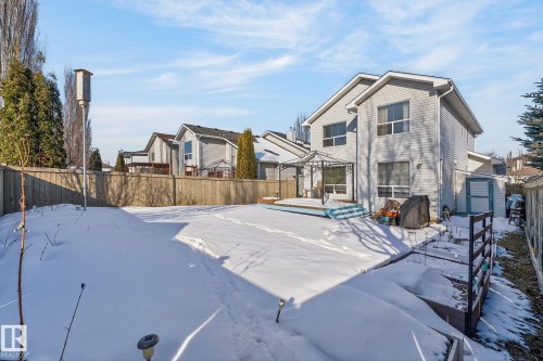 The property features a large yard with a wooden fence and a multi-level deck - 19 Escada Close, St. Albert, AB - Outdoor