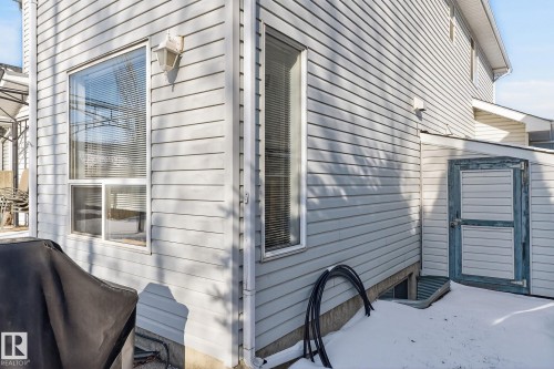 The property exterior features light-colored siding, multiple windows, and an outdoor light fixture - 19 Escada Close, St. Albert, AB - Outdoor With Exterior