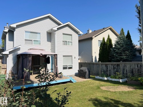 The property features a two-story exterior with light-colored siding and a backyard with a deck - 19 Escada Close, St. Albert, AB - Outdoor