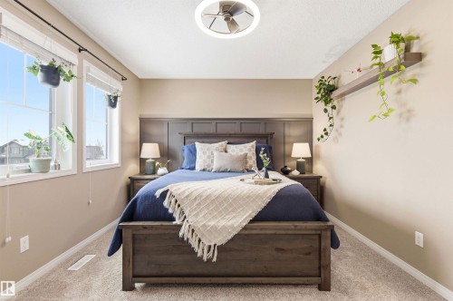 The property features light-colored walls and carpet flooring, providing a neutral backdrop - 3247 Cherry Crescent, Edmonton, AB - Indoor Photo Showing Bedroom