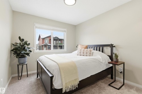 This room features a window providing natural light, light-colored walls, and carpeting - 3247 Cherry Crescent, Edmonton, AB - Indoor Photo Showing Bedroom