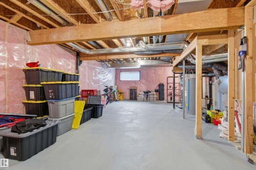 The property features an unfinished basement with exposed wooden beams, insulation, and a concrete floor - 3247 Cherry Crescent, Edmonton, AB - Indoor Photo Showing Basement