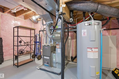 The property includes a water heater and furnace, providing essential utilities - 3247 Cherry Crescent, Edmonton, AB - Indoor Photo Showing Basement