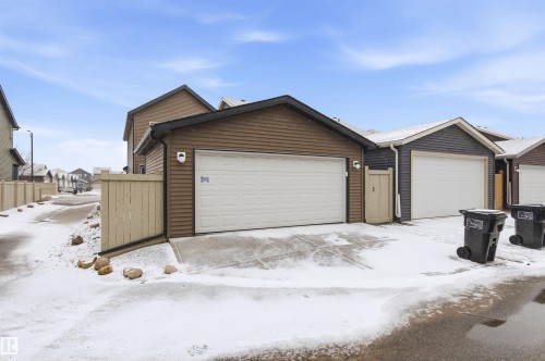 The property features a garage with brown siding and a light-colored garage door - 3247 Cherry Crescent, Edmonton, AB - Outdoor With Exterior