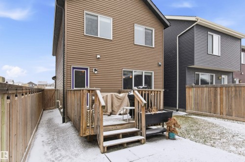 The property features a private wood deck with stairs leading to a concrete patio - 3247 Cherry Crescent, Edmonton, AB - Outdoor With Exterior