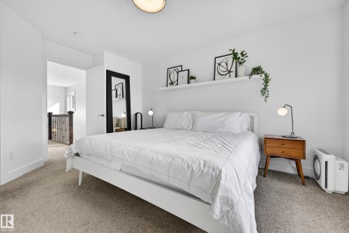 Bedroom featuring plush carpet flooring, white walls, and a recessed ceiling light - 7624 91 Avenue, Edmonton, AB - Indoor Photo Showing Bedroom