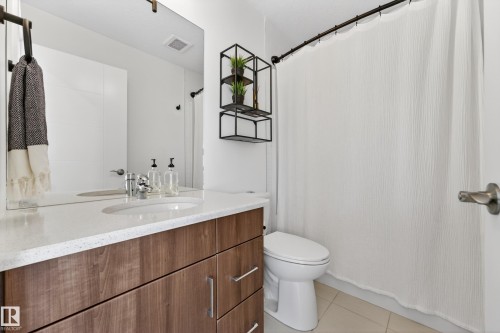 Bathroom featuring a vanity with a white countertop, a mirror, and a shower with a white curtain - 7624 91 Avenue, Edmonton, AB - Indoor Photo Showing Bathroom