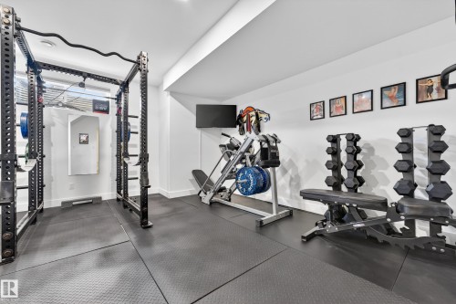 Dedicated workout space featuring padded flooring, white walls, and recessed lighting - 7624 91 Avenue, Edmonton, AB - Indoor Photo Showing Gym Room