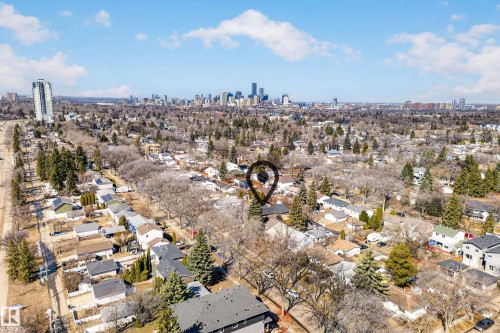 Aerial view showcasing the residential area with a prominent city skyline visible in the distance - 7624 91 Avenue, Edmonton, AB - Outdoor With View