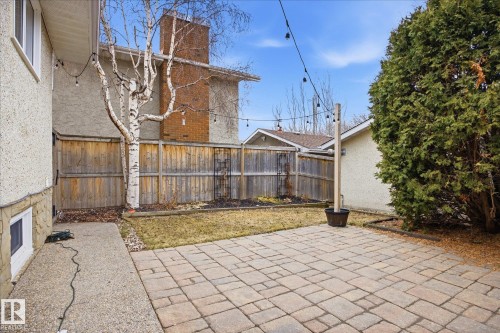 Paved patio area featuring a stone paver surface and string lighting - 10222 73 Street, Edmonton, AB 