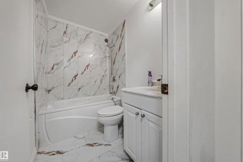 Bathroom featuring a white bathtub, toilet, and vanity with a sink - 2831 36 Street, Edmonton, AB - Indoor Photo Showing Bathroom