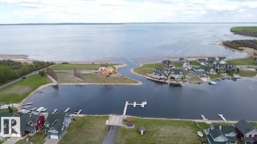 This property features a waterfront location with boat slips and direct access to a large body of water - 13 Sunset Harbour, Rural Wetaskiwin County, AB 