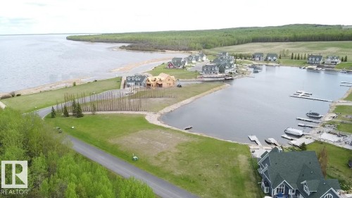 The property is located on a body of water with a marina, providing direct access to the water - 13 Sunset Harbour, Rural Wetaskiwin County, AB 