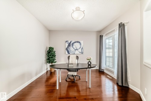 This room features hardwood floors, light-colored walls, and a window with white trim - 1330 114B Street, Edmonton, AB - Indoor