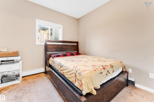 This room features carpeted flooring and neutral-toned walls, complemented by a window providing natural light - #418 392 Silver Berry Road Nw, Edmonton, AB - Indoor Photo Showing Bedroom