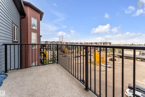 This property features a balcony with a concrete surface and black metal railings - #418 392 Silver Berry Road Nw, Edmonton, AB - Outdoor With Balcony With Exterior
