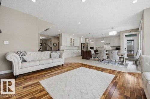 The open-concept living area features hardwood flooring, recessed lighting, and a neutral color palette - 76 Newgate Way, St. Albert, AB - Indoor Photo Showing Living Room
