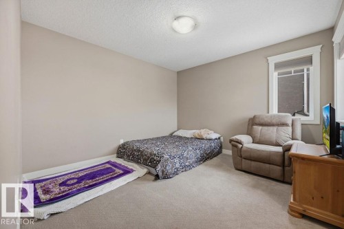 This room features neutral-toned walls, carpeted flooring, and a window with white trim - 76 Newgate Way, St. Albert, AB - Indoor Photo Showing Bedroom
