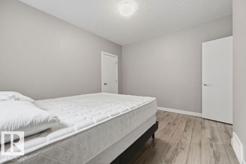 This room features light grey walls and light wood-style flooring, providing a neutral aesthetic - 76 Newgate Way, St. Albert, AB - Indoor Photo Showing Bedroom