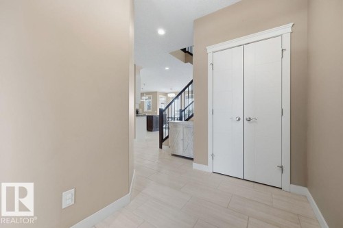 Entryway featuring light-colored tile flooring, a white bi-fold closet, and neutral-toned walls - 76 Newgate Way, St. Albert, AB - Indoor Photo Showing Other Room