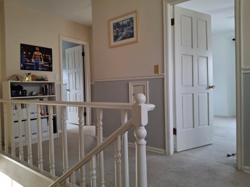 The property features a hallway with white paneled doors, light-colored walls, and carpeted flooring - 13112 63 Avenue, Edmonton, AB - Indoor Photo Showing Other Room