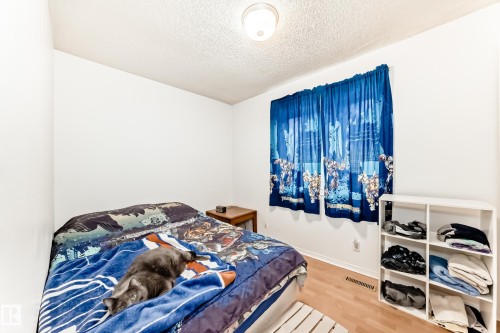 Bedroom featuring a textured ceiling and wood finished floors - 15515 92A Avenue, Edmonton, AB - Indoor Photo Showing Bedroom