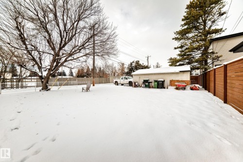 Yard layered in snow with a fenced backyard and a patio area - 15515 92A Avenue, Edmonton, AB - Outdoor