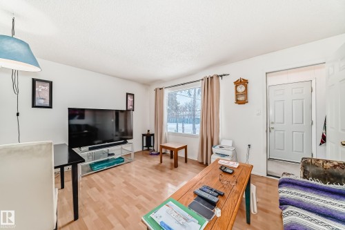 Living room with light wood-type flooring and a textured ceiling - 15515 92A Avenue, Edmonton, AB - Indoor Photo Showing Living Room