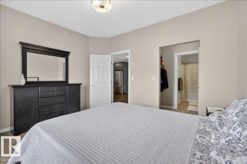 The bedroom features neutral-toned walls and carpeted flooring - 413 2203 44 Avenue, Edmonton, AB - Indoor Photo Showing Bedroom