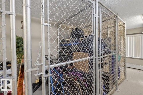 The property offers dedicated storage areas, featuring chain-link fencing with a lockable gate and ample space for belongings - 413 2203 44 Avenue, Edmonton, AB - Indoor