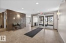 The property features a lobby with tiled flooring, recessed lighting, and a textured accent wall - 413 2203 44 Avenue, Edmonton, AB  - Indoor Photo Showing Other Room 