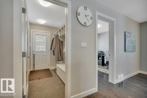 Entryway featuring light-colored walls, tile flooring, and built-in storage with shelving and a bench - 9540 142 Street, Edmonton, AB - Indoor Photo Showing Other Room