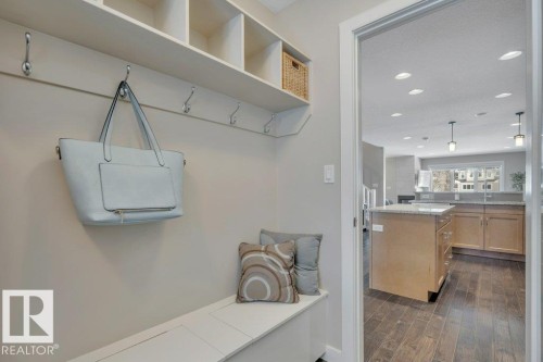 Entryway with built-in bench seating, upper shelving, and wall hooks - 9540 142 Street, Edmonton, AB - Indoor Photo Showing Other Room