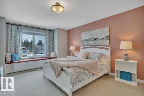 This room features soft carpeting and a window seat with storage, providing a comfortable spot with a view of the outside - 9540 142 Street, Edmonton, AB - Indoor Photo Showing Bedroom