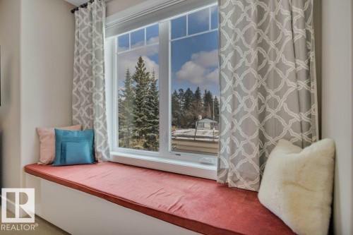 Window seat with a view of evergreen trees in the front yard. - 9540 142 Street, Edmonton, AB - Indoor Photo Showing Other Room