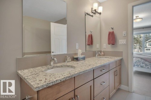 Bathroom vanity featuring dual sinks with chrome faucets, granite countertops, separate shower and tub. - 9540 142 Street, Edmonton, AB - Indoor Photo Showing Bathroom