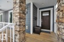 The property features a welcoming entrance with a dark wood door, decorative glass inserts, and a covered porch - 9540 142 Street, Edmonton, AB  - Outdoor With Deck Patio Veranda With Exterior 