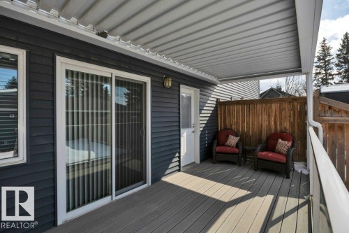 Exterior deck featuring a white overhead deck covering that has flexible panels to adjust the light you desire. Deck boards are new & so is the deck railing - 9540 142 Street, Edmonton, AB - Outdoor With Deck Patio Veranda With Exterior