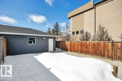 Detached garage with dark grey siding, a white door, and a single window - 9540 142 Street, Edmonton, AB - Outdoor With Exterior