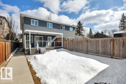 The property features a private backyard with a wooden fence and a concrete walkway - 9540 142 Street, Edmonton, AB - Outdoor With Deck Patio Veranda