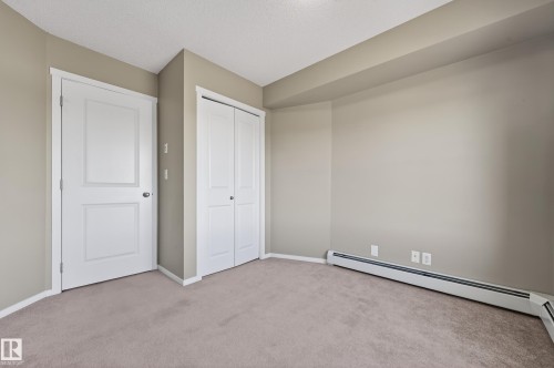 doors with panel detailing - 404 5370 Chappelle Road, Edmonton, AB - Indoor Photo Showing Other Room